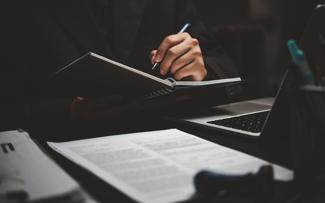 learning online class by using laptop computer and writing notebook at workplace